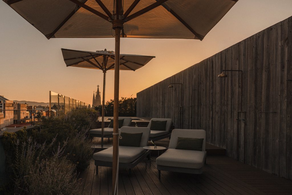 Sun deck with loungers on Alma Barcelona rooftop terrace
